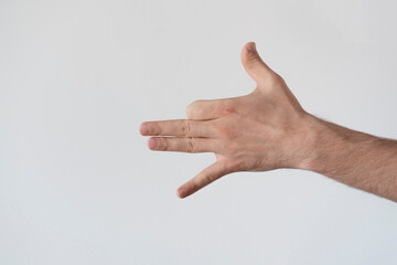 human hand making the shadow of dog on the wall