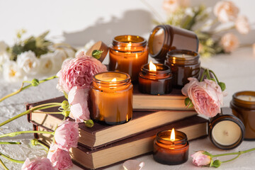 A set of different aroma candles in brown glass jars. Scented handmade candle. Soy candles are burning in a jar. Aromatherapy and relax in spa and home. Fire in brown jar.