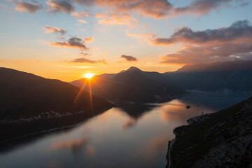 Aerial view ofSunset at Perast of Montenegro, reflection of clouds on sea water colorful sky and kotor bay