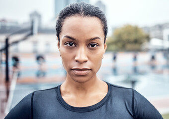 Fitness, exercise and portrait of a woman athlete in the city for an outdoor run or sports training. Serious, motivation and face of young female runner with crossed arms after cardio workout outside