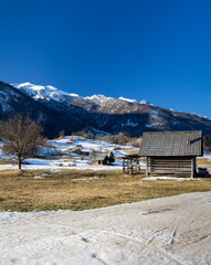Naklejka premium Typical landscape with wooden log cabins near Bohinjska Bistrica, Triglavski national park, Slovenia