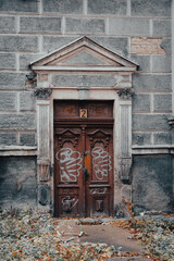 polish artichetcure, old doors in beautiful building, vandalized with graffiti