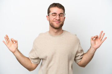 Young caucasian man isolated on white background in zen pose