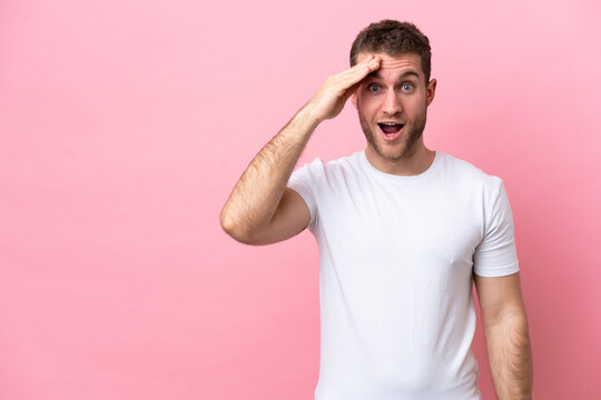 Young caucasian man isolated on pink background has realized something and intending the solution