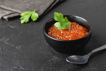 Red salmon caviar with parsley in a bowl