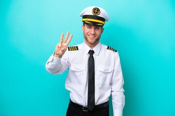 Airplane caucasian pilot isolated on blue background happy and counting three with fingers