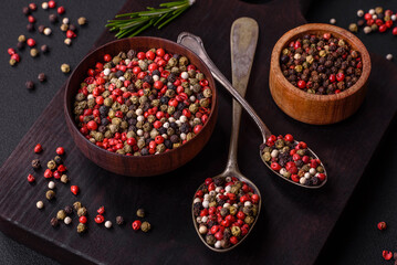 Spice allspice of different colors pink, white, green not ground in a wooden saucer