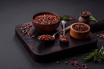 Spice allspice of different colors pink, white, green not ground in a wooden saucer