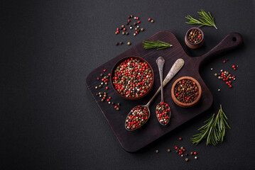 Fototapeta premium Spice allspice of different colors pink, white, green not ground in a wooden saucer