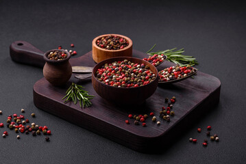 Spice allspice of different colors pink, white, green not ground in a wooden saucer