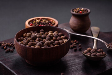 Spice allspice brown color not ground in a wooden saucer. Asian food