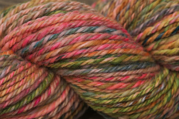 Closeup of colourful handspun and handdyed pure organic merino sheep wool yarn , spun on a spinning...