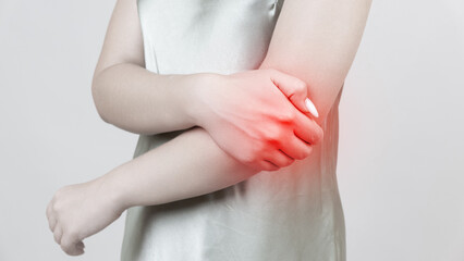 young woman experiencing pain in elbow joint