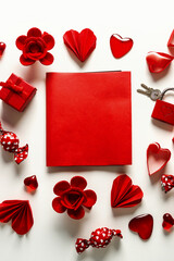 Red Valentines day card mock up with paper hearts, candies and flowers on white background, top view