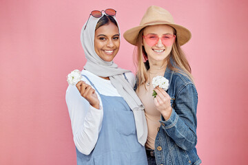 Friends, diversity and fashion women portrait with spring flowers on a pink background with a happy...