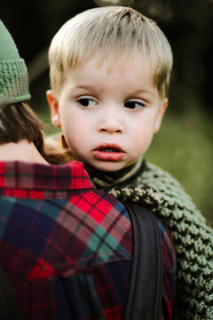 Mother holding her little adorable son overy her shoulder.