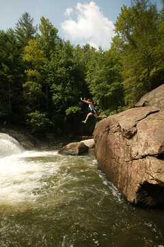 Jennifer Foster leaps into the pool below Turtleback Falls on the Whitewater River near Cashiers, NC.