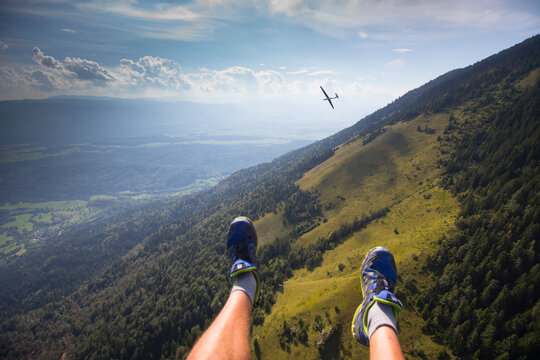 Feet of paraglider flying above Slovenian Alps, near Begunje and Radovljica, Upper Carniola, Slovenia