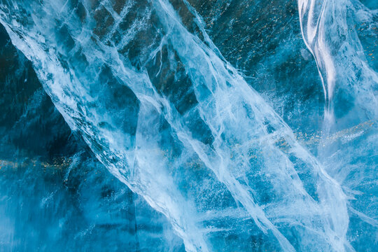 Cracks and air bubbles form complex structures in glacier ice exposed on the surface of Rabotbreen, Svalbard.