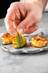 chef hand cooking fried big tiger shrimp on plate
