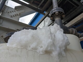 Foaming chemical cleaning water treatment plant reaction of fresh water and impurities. The photo...