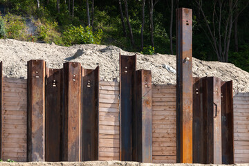 Strengthening the slope of the ravine, rusty steel beams