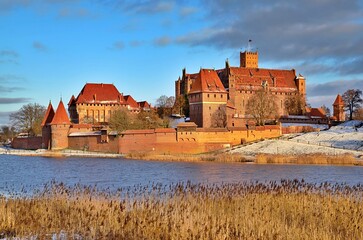 Naklejka na ściany i meble Malbork castle in Pomerania region of Poland. UNESCO World Heritage Site. Teutonic Knights' fortress also known as Marienburg. Nogat river
