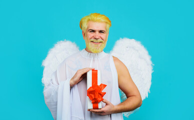 Smiling man in angel wings. Valentine present. Cupid with gift box. Valentines day shopping.