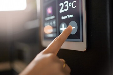 Smart home system, wall and woman hands with digital app monitor for thermostat heating,...