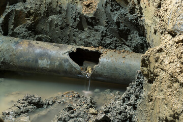old asbestos cement water pipe 250 mm diameter broken by external force, impact load - 565613154