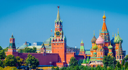 Fototapeta premium Spasskaya Tower of Moscow Kremlin and Cathedral of Vasily the Blessed (Saint Basil's Cathedral) on Red Square in summer day. Panoramic view. Moscow. Russia