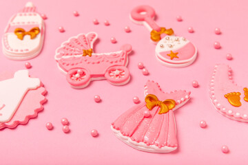 Set of delicious baby shower cookies on a pink textured background. Gender cookies.Baby shower party. Close-up. Flat lay. Place for text.