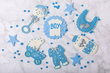 Set of delicious baby shower cookies on a white marble background. Gender cookies.Baby shower party. Close-up. Flat lay. Place for text.