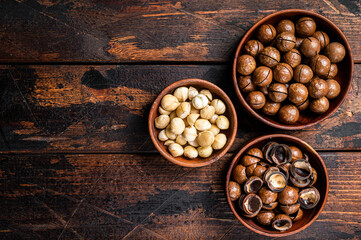 Unshelled Macadamia nuts ready to eat. Wooden background. Top view. Copy space