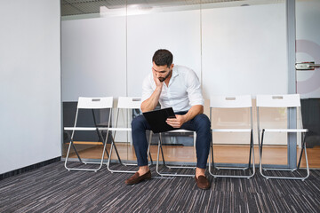 Worried man in waiting room waiting for job interview