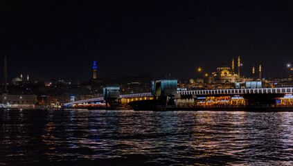 Fototapeta na wymiar Night view of Galata bridge. Istanbul night landscapes. Mosques and estuary. Istanbul evenings. Golden Horn metro bridge.