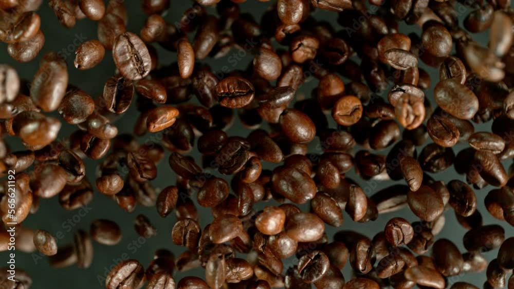 Poster super slow motion of rotating coffee beans on black background. filmed on high speed cinema camera, 