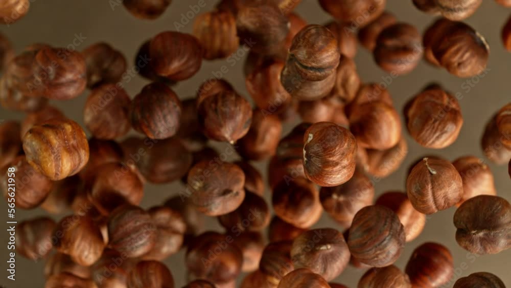 Poster super slow motion of rotating hazelnuts up to the air. filmed on high speed cinema camera, 1000fps, 
