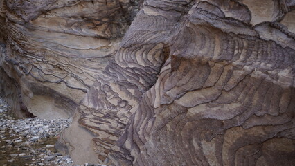 Colorful rock formations on the hiking trail in the canyon of Wadi Ghuweir in Dana in Jordan in the month of January