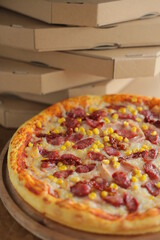 pizza with corn, mozzarella, sausage and meat. Pizza with boxes