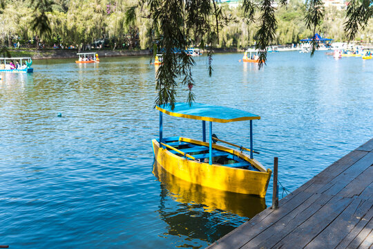 Baguio City, Philippines - A small wooden boat by the dock of a man-made lake in Burnham Park.