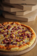 pizza with corn, mozzarella, sausage and meat. Pizza with boxes