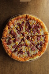 pizza with corn, mozzarella, sausage and meat. Pizza with boxes