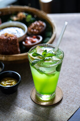 Cocktail with lime and mint on a table in a restaurant