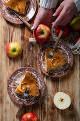 Obraz na płótnie Canvas woman cuts an apple for making apple pie, top view still life