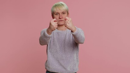 Angry aggressive woman showing fig negative gesture, you dont get it anyway. Rapacious, avaricious acquisitive. Body language. Refusal fig sign. Greedy girl on pink background. Lgbt gay lesbian people - Powered by Adobe