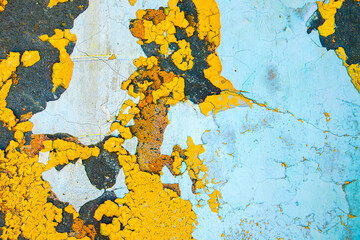 Abstract background. Closeup fragment of cracked and peeling painted wall.	