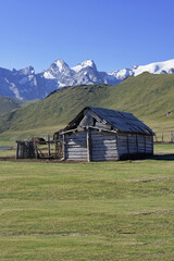 Lonely wooden shelter near the alpine Köl-Suu lake, Kurumduk valley, Naryn province, Kyrgyzstan