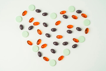 Many different tablet pills on white background, flat lay, with copy space.