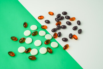 Many different tablet pills on color background, flat lay, with copy space.